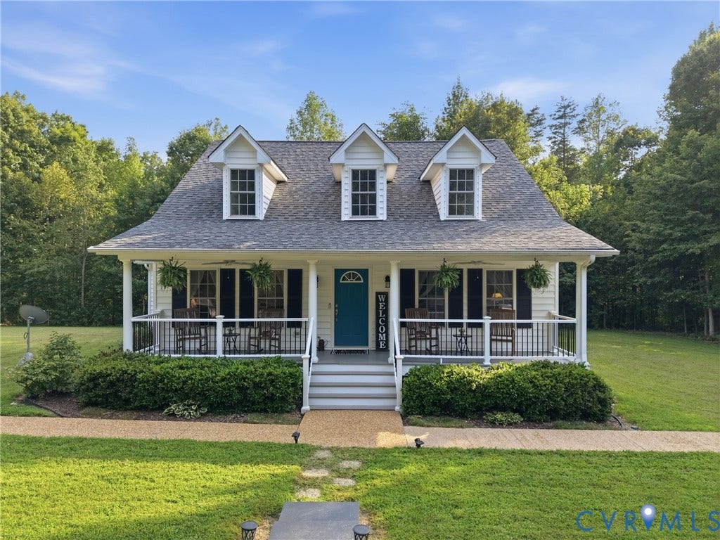 5295 Chimney Springs Drive, Saunders Acres, Goochland, VA 23063 White siding exterior with a covered front porch, dark shutters, and a teal entry door