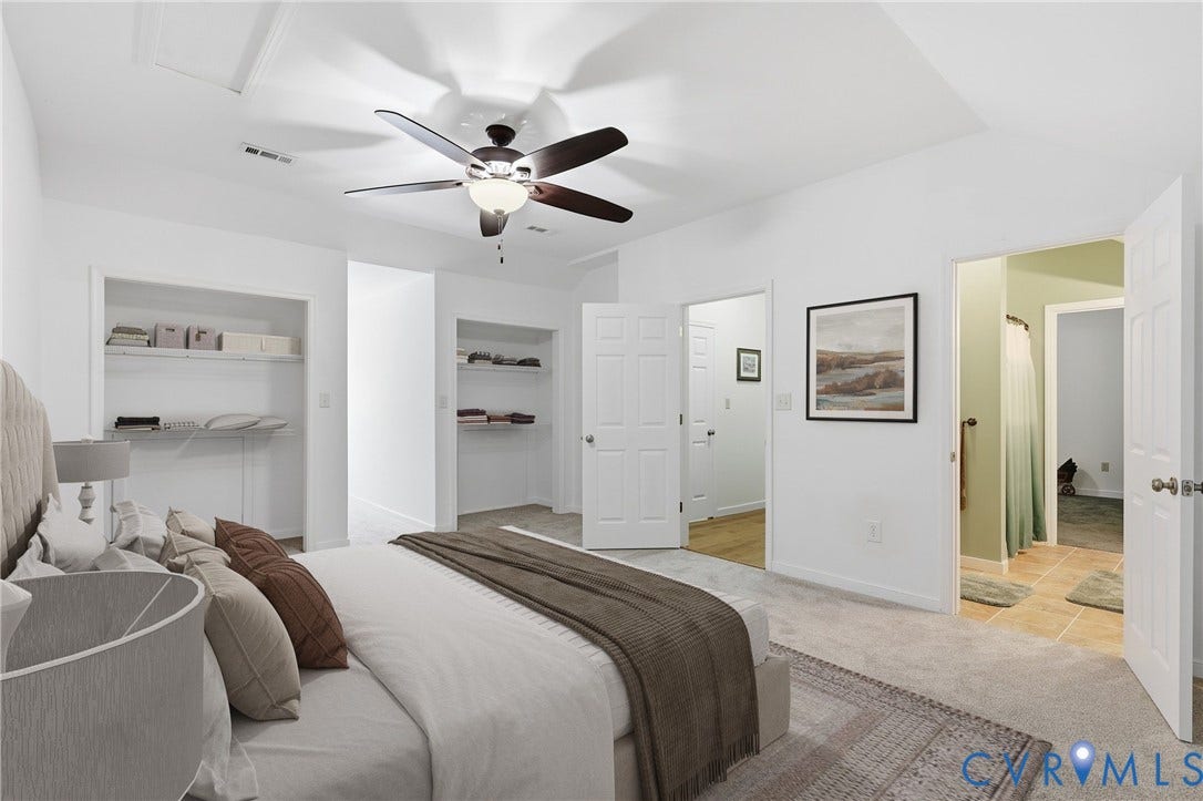 5295 Chimney Springs Drive, Saunders Acres, Goochland, VA 23063 Virtually staged- White walls with gray carpet flooring, a ceiling fan with integrated lighting, and two open closet spaces with shelving
