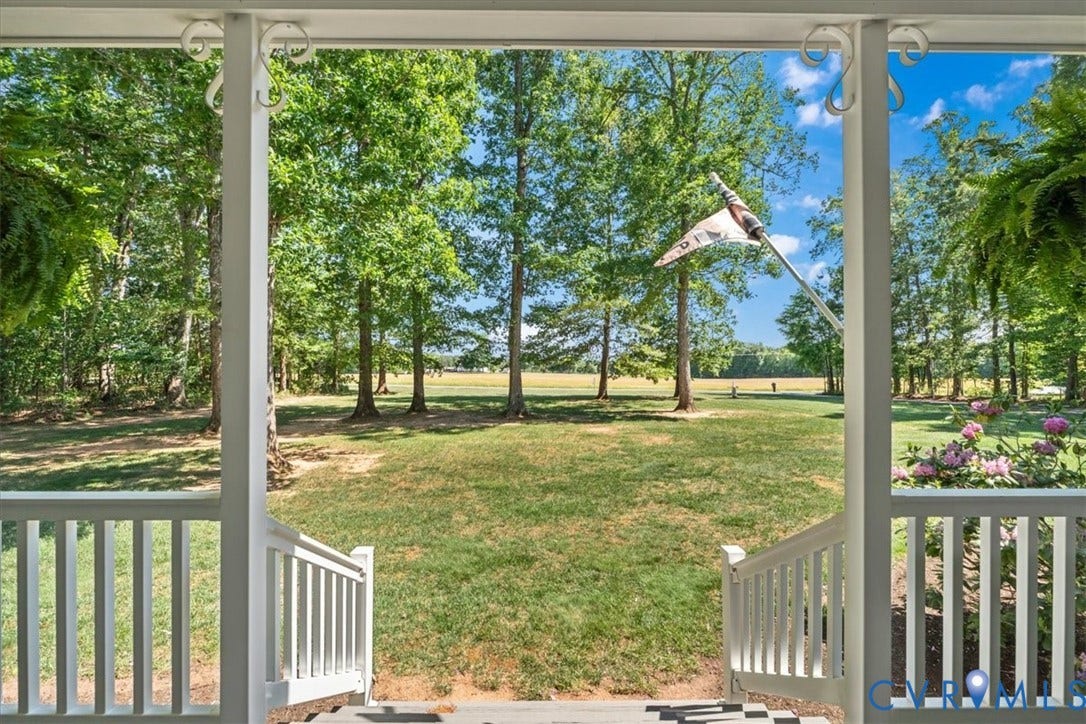 3060 Moyer Road, Powhatan, VA 23139 Porch featuring white railings and columns, with a broad lawn and mature trees beyond
