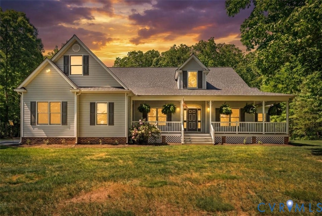 3060 Moyer Road, Powhatan, VA 23139 Charming farmhouse-style residence featuring a classic gabled roofline with dormer windows, horizontal siding exterior, and a full-width front porch with decorative railings
