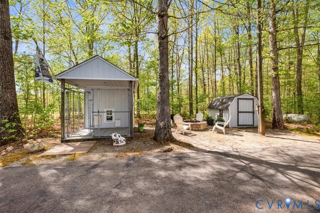 3060 Moyer Road, Powhatan, VA 23139 Wooded property with a detached storage shed and a separate kennel structure