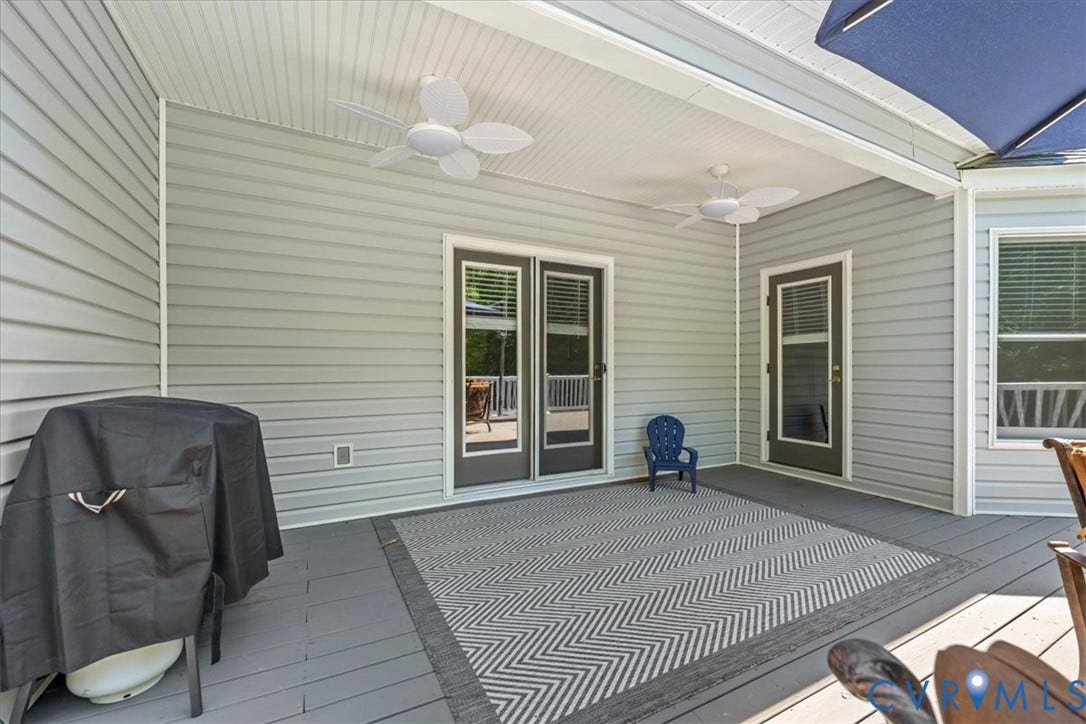 3060 Moyer Road, Powhatan, VA 23139 Covered patio featuring two ceiling fans and durable siding