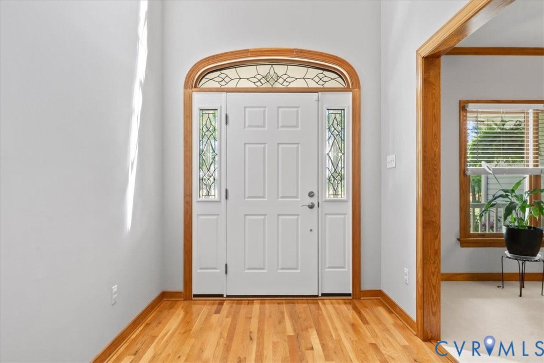 3060 Moyer Road, Powhatan, VA 23139 Entryway featuring hardwood flooring, a paneled door with sidelights, and an arched transom window