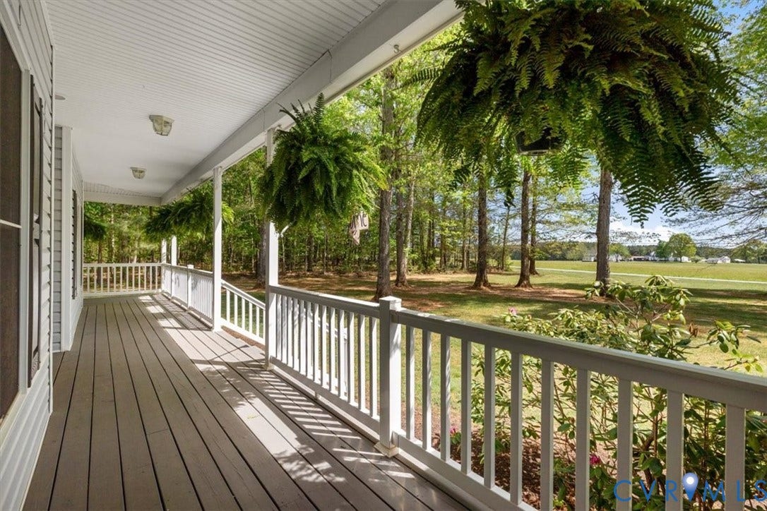 3060 Moyer Road, Powhatan, VA 23139 Expansive covered porch with wood-finish flooring, white railing, and multiple ceiling lights