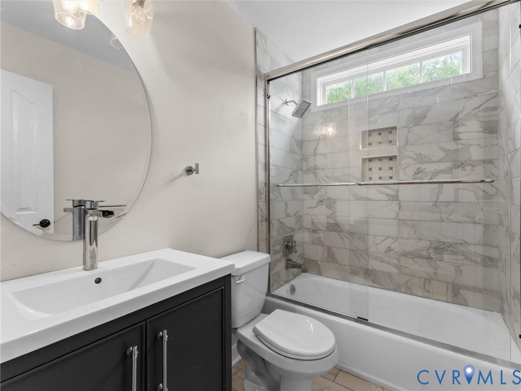 5017 Sadler Glen Place, Glen Allen, VA 23060 2nd floor bedroom ark-toned vanity with integrated sink, chrome faucet, and circular mirror