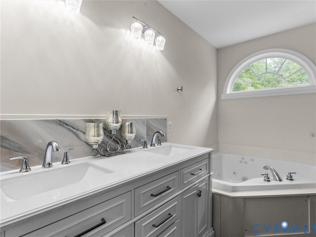 5017 Sadler Glen Place, Glen Allen, VA 23060 Dual vanity with undermount sinks, chrome fixtures, and a marbled backsplash