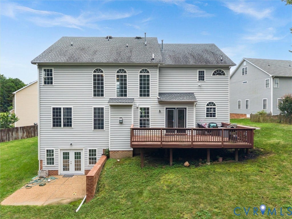 5017 Sadler Glen Place, Glen Allen, VA 23060 Multi-level siding exterior featuring an elevated wood-finish deck, lower-level patio, and multiple arched windows
