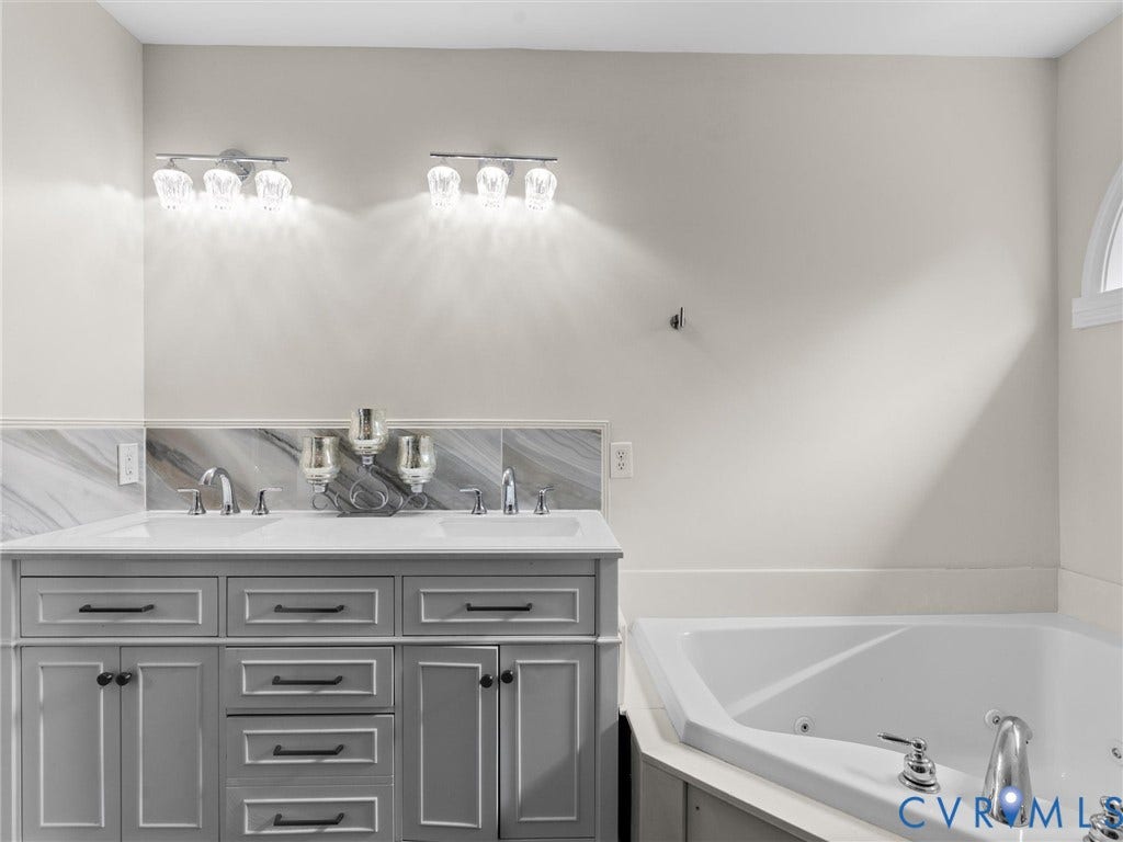 5017 Sadler Glen Place, Glen Allen, VA 23060 Dual vanity with white countertop, chrome fixtures, and a tiled backsplash