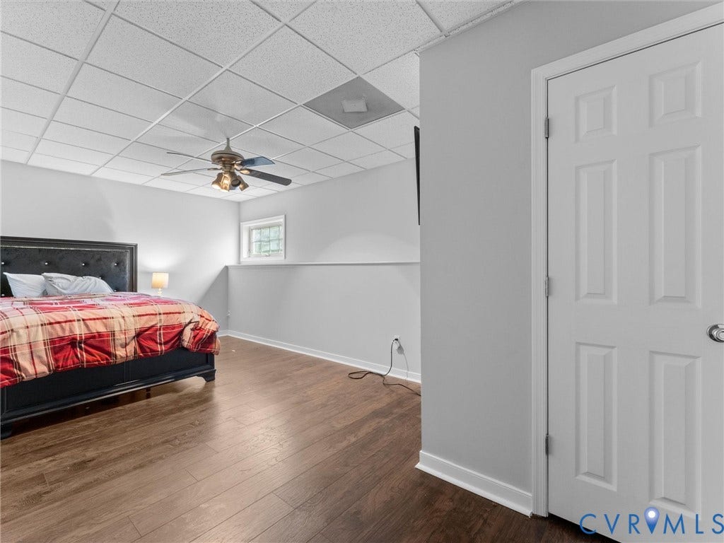 5017 Sadler Glen Place, Glen Allen, VA 23060 bedroom in basement- Wood-finish flooring, drop ceiling, white trim, and a ceiling fan with integrated lighting