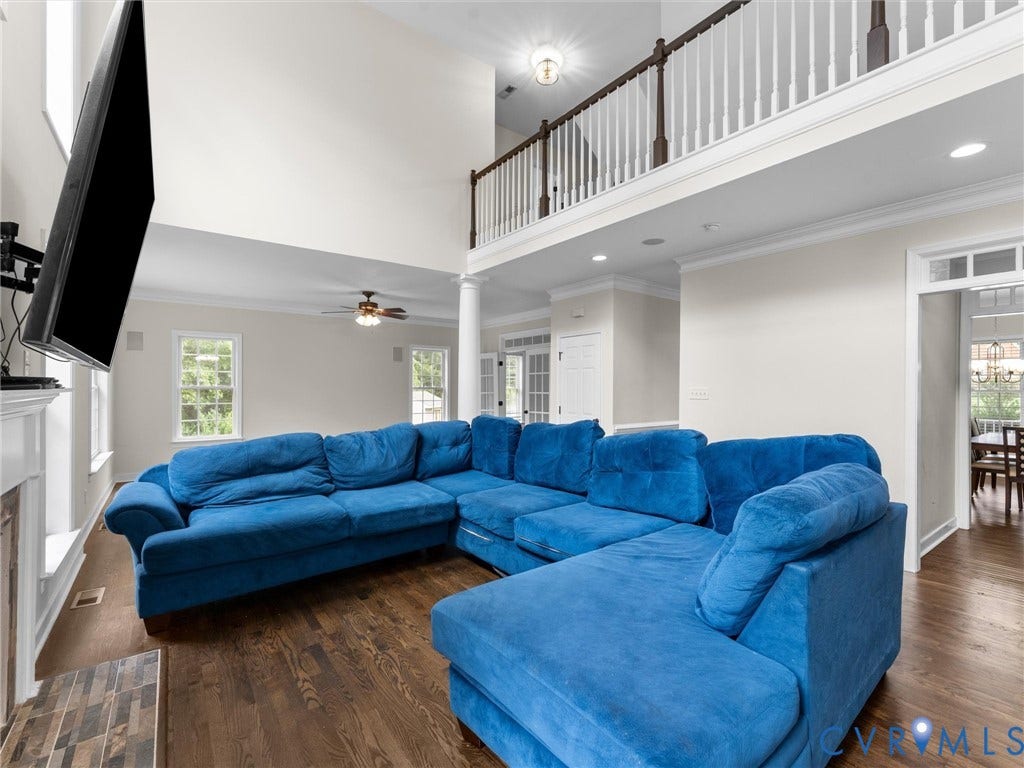 5017 Sadler Glen Place, Glen Allen, VA 23060 Soaring ceilings, rich wood-finish flooring, and a second-story balcony with white balusters