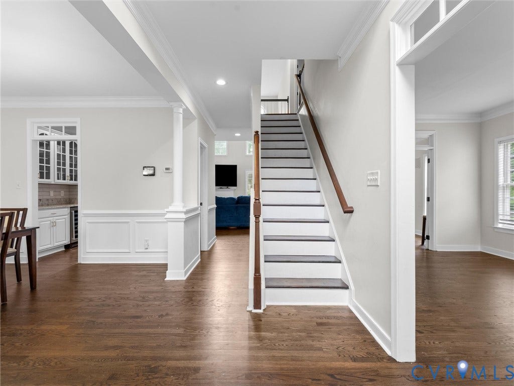 5017 Sadler Glen Place, Glen Allen, VA 23060 Hardwood flooring throughout, a staircase with dark treads and wood handrail, wainscoting, and recessed lighting