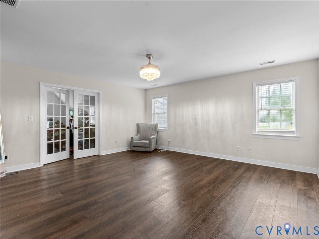 5017 Sadler Glen Place, Glen Allen, VA 23060 Wood-finish flooring, white walls, double French doors, recessed windows, and a semi-flush mount light fixture