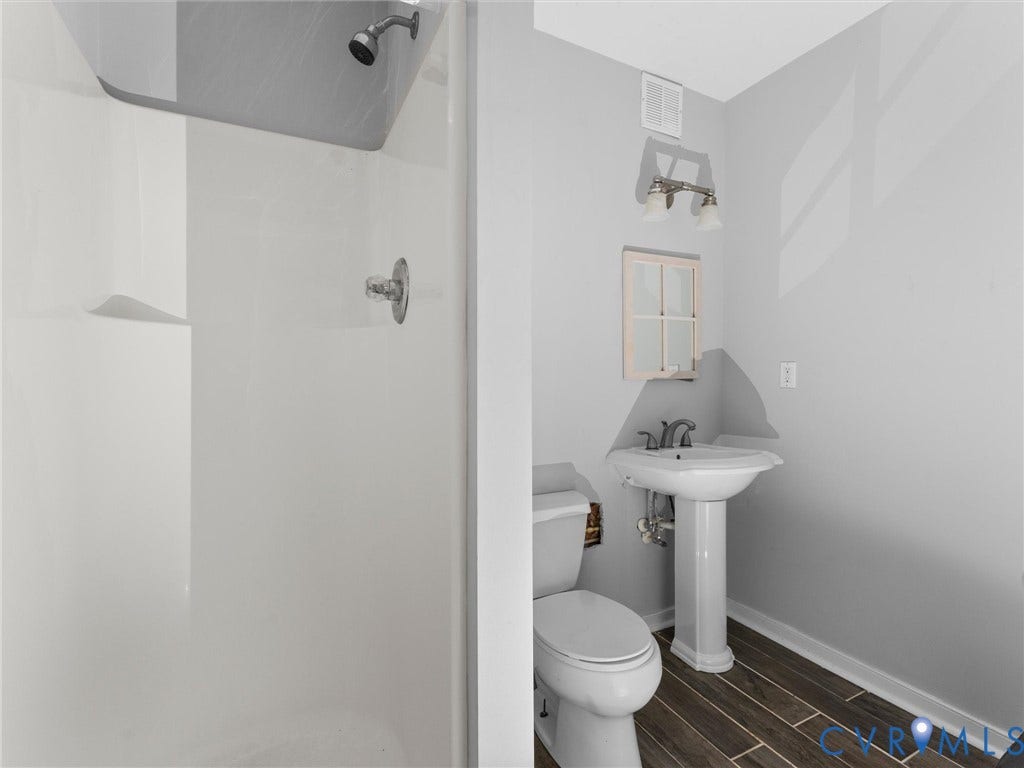 5017 Sadler Glen Place, Glen Allen, VA 23060 Full bathroom featuring a white shower surround, pedestal sink, and dark wood-finish flooring
