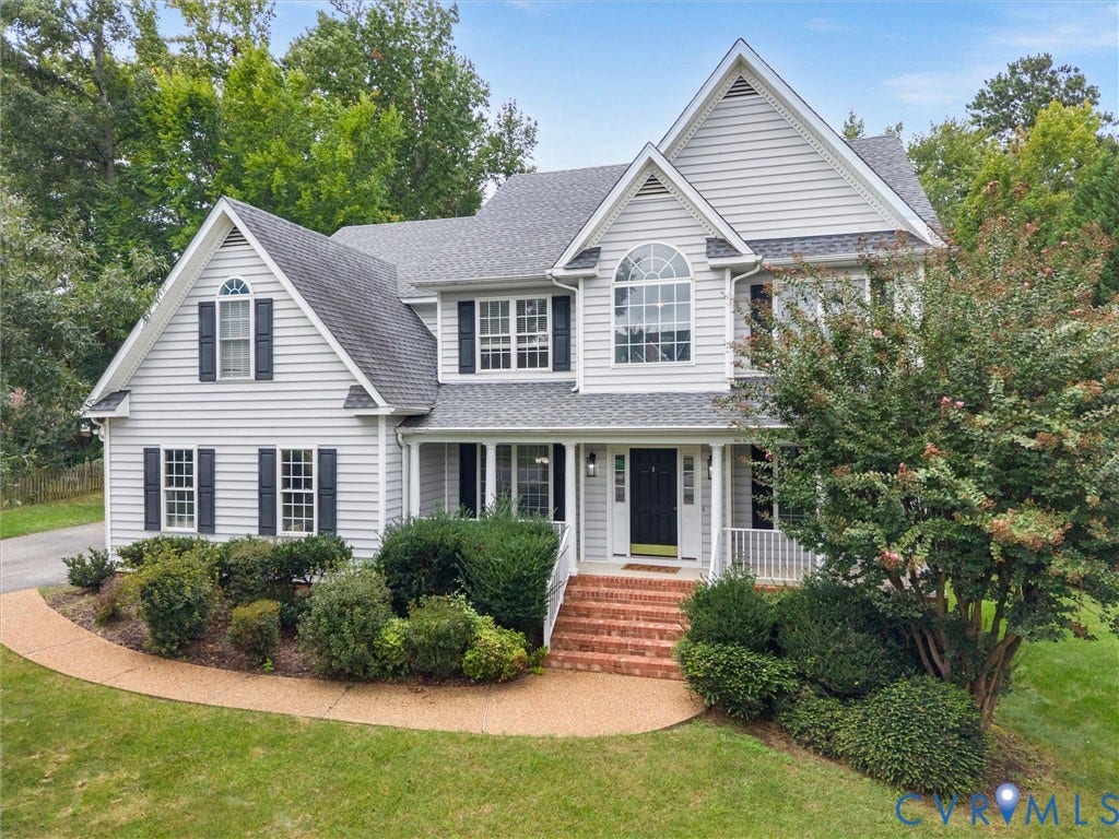 5017 Sadler Glen Place, Glen Allen, VA 23060 Two-story residence featuring light gray siding, dark shutters, a front porch with white railings, and mature landscaping