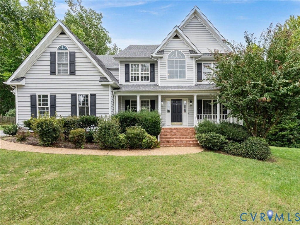 5017 Sadler Glen Place, Glen Allen, VA 23060 Two-story residence with light gray siding and dark shutters, featuring a prominent gable roofline