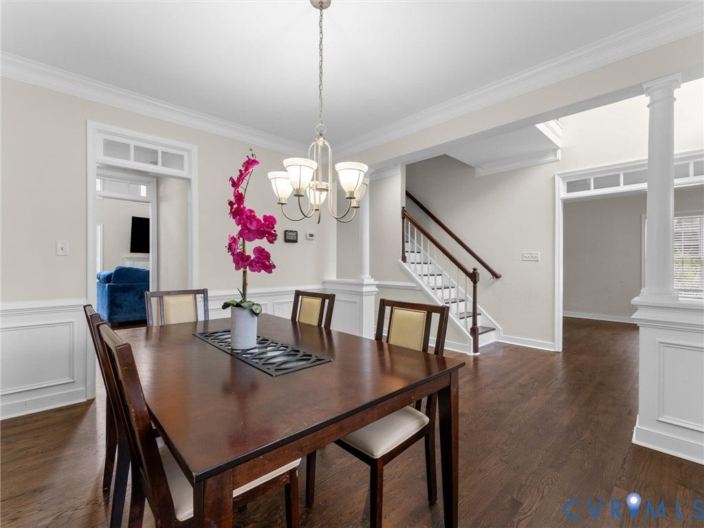 5017 Sadler Glen Place, Glen Allen, VA 23060 Hardwood flooring, wainscoting, crown molding, and a chandelier with a light-toned finish