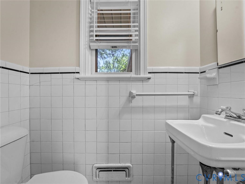 White square tile walls with black accent trim