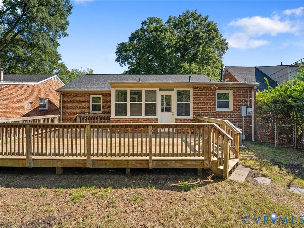 Expansive wood deck with railing and stairs