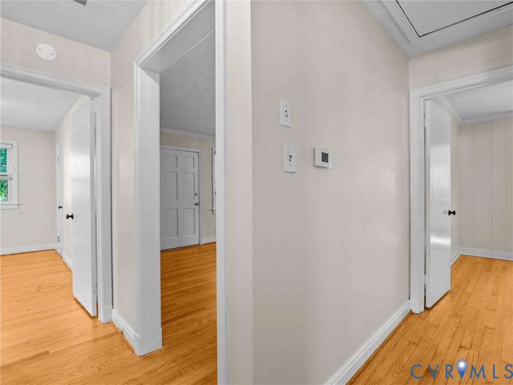 Hardwood flooring throughout, white trim, and white painted walls