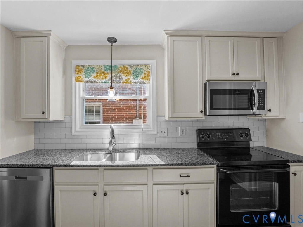 Kitchen featuring granite countertops, a stainless steel dishwasher, an over-range microwave, a built-in electric range, and subway tile backsplash