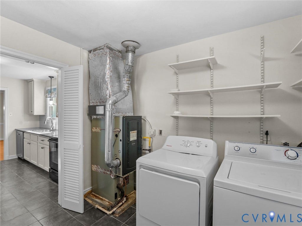 Laundry area with wall-mounted shelving and tiled flooring