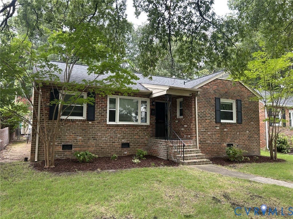 Brick exterior with a gabled roof and black shutters
