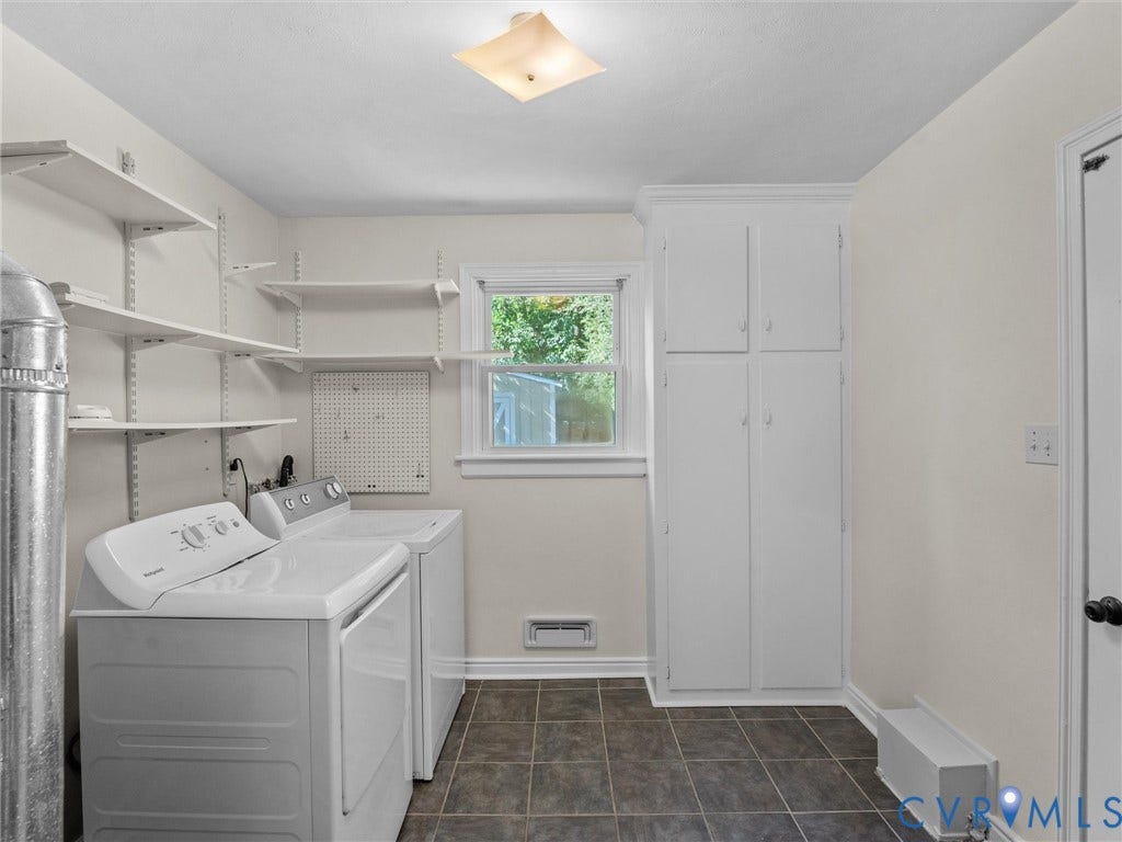 Tile flooring, built-in storage cabinetry, adjustable wall shelving, and a prominent window