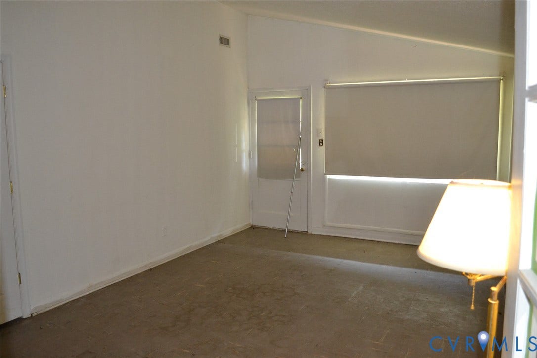 3024 Bensley Road, Ampthill, VA 23237 Vaulted ceiling, neutral wall tones, interior door, window with roller shade, and light-toned flooring