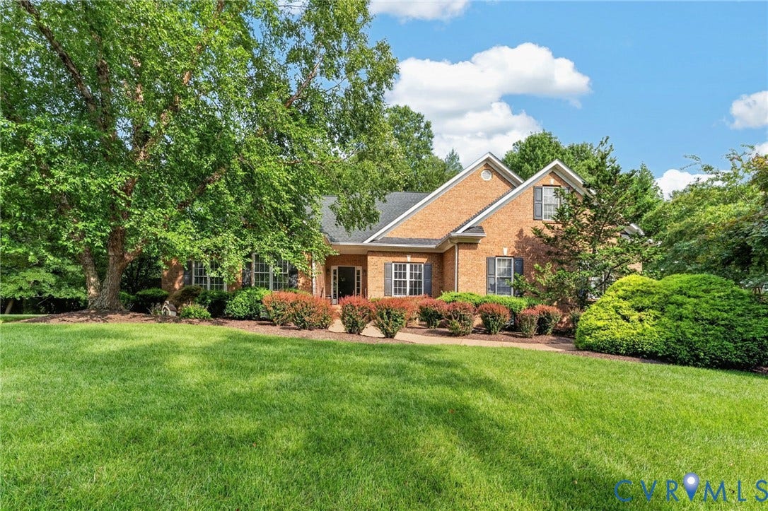 Brick Colonial residence set on expansive manicured grounds with mature landscaping