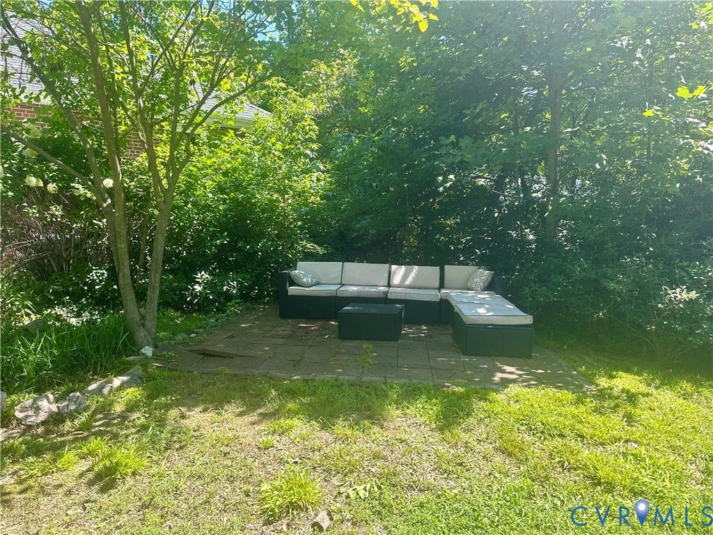 6513 Hagueman Drive, Richmond, VA 23225 Paved patio area surrounded by mature trees and natural landscaping