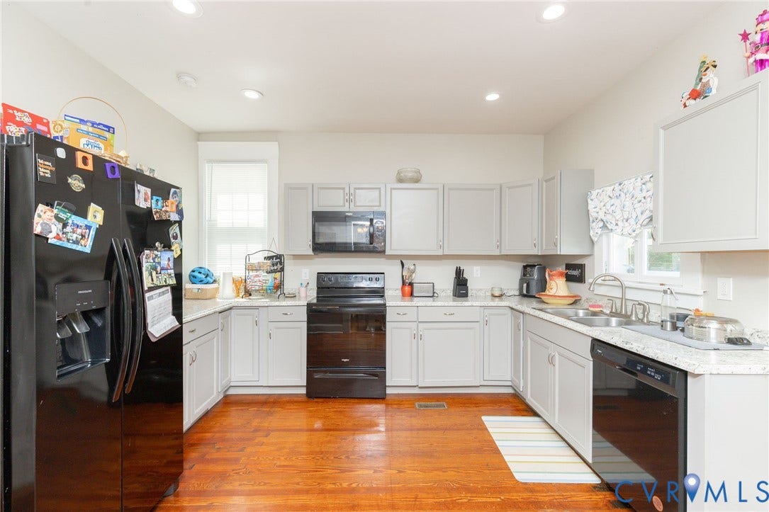 2726 Hanes Avenue, Brookland Park, Richmond, VA 23222 U-shaped kitchen featuring light gray cabinetry, white countertops, black appliances, and wood-finish flooring
