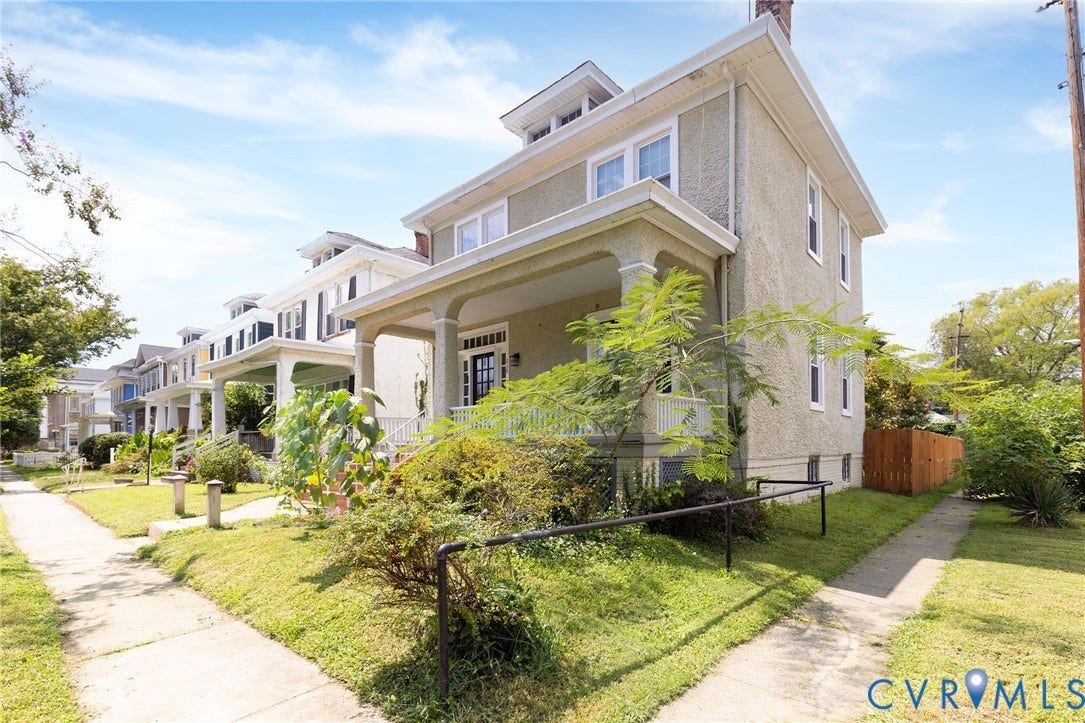2726 Hanes Avenue, Brookland Park, Richmond, VA 23222 Three-story stucco exterior with a covered front porch, prominent dormer windows, and a side walkway