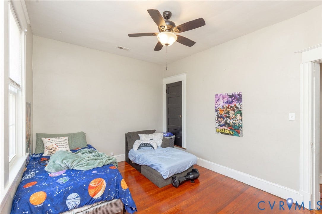 2726 Hanes Avenue, Brookland Park, Richmond, VA 23222 Wood-finish flooring, white walls, dark paneled door, and a ceiling fan with integrated lighting