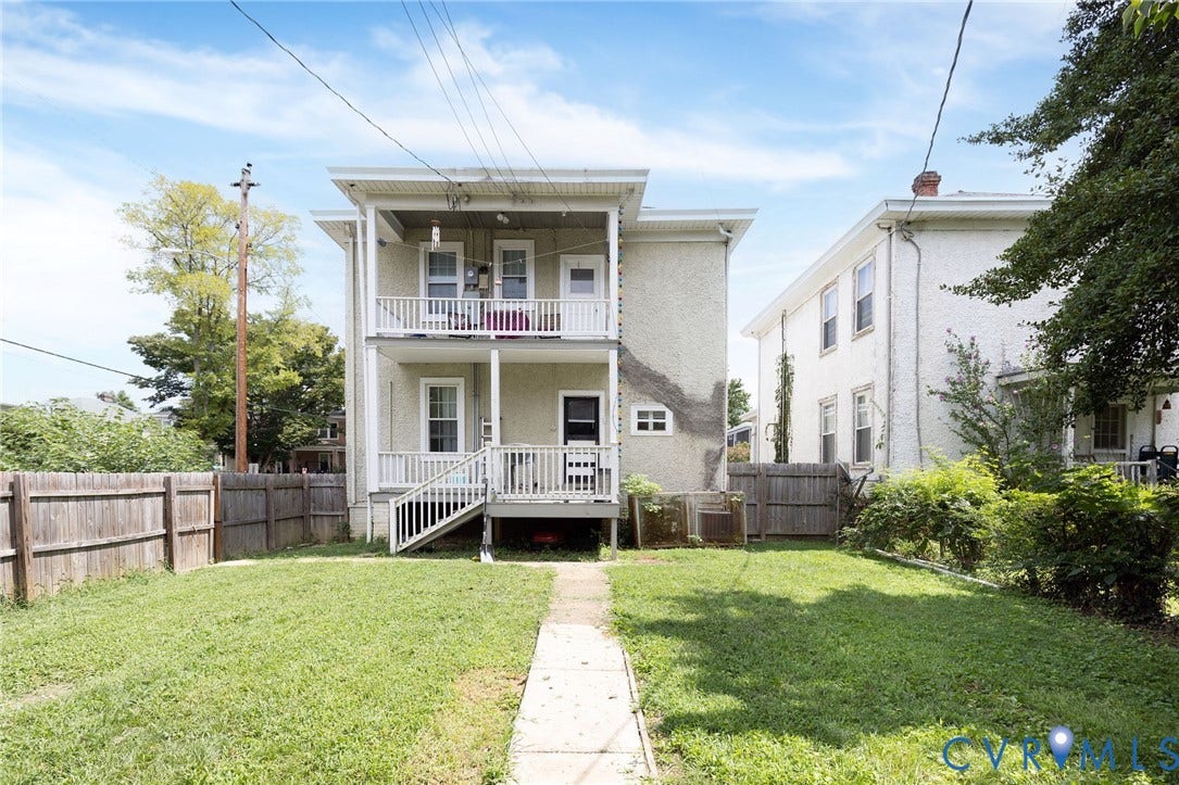 2726 Hanes Avenue, Brookland Park, Richmond, VA 23222 Rear exterior featuring two levels of balconies, a fenced yard, and a concrete pathway