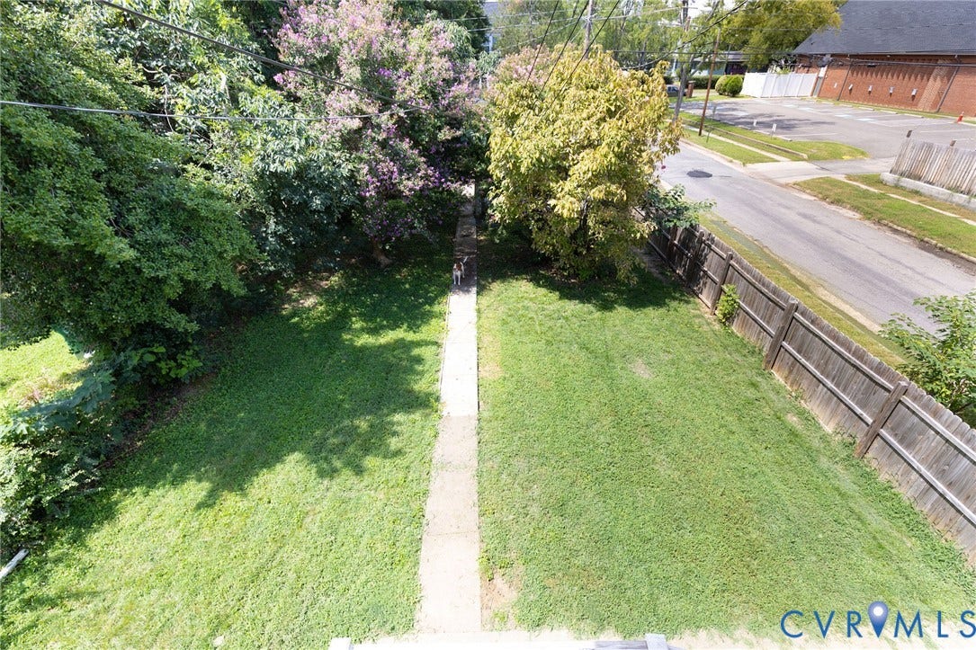 2726 Hanes Avenue, Brookland Park, Richmond, VA 23222 Expansive lawn area with a concrete pathway and a wood fence boundary