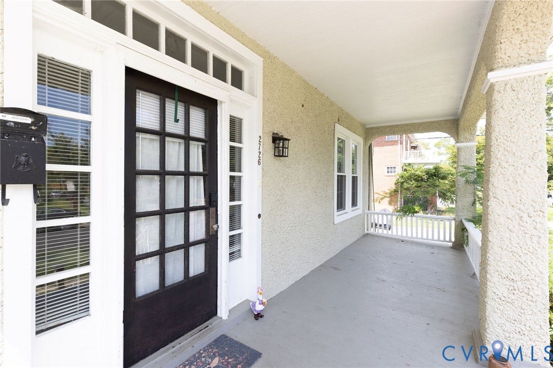 2726 Hanes Avenue, Brookland Park, Richmond, VA 23222 Covered front porch with stucco exterior, architectural exterior lighting, white window frames, and a paneled front door with sidelights
