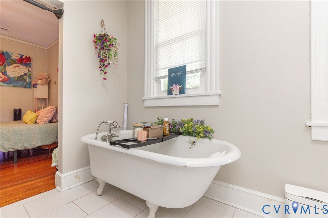 2726 Hanes Avenue, Brookland Park, Richmond, VA 23222 Freestanding clawfoot tub with chrome fixtures, white tile flooring, and a window with blinds in master bath