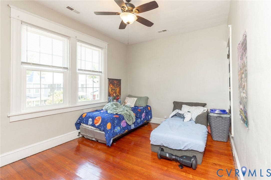 2726 Hanes Avenue, Brookland Park, Richmond, VA 23222 Hardwood flooring, painted walls, two large windows with blinds, and a ceiling fan with integrated lighting