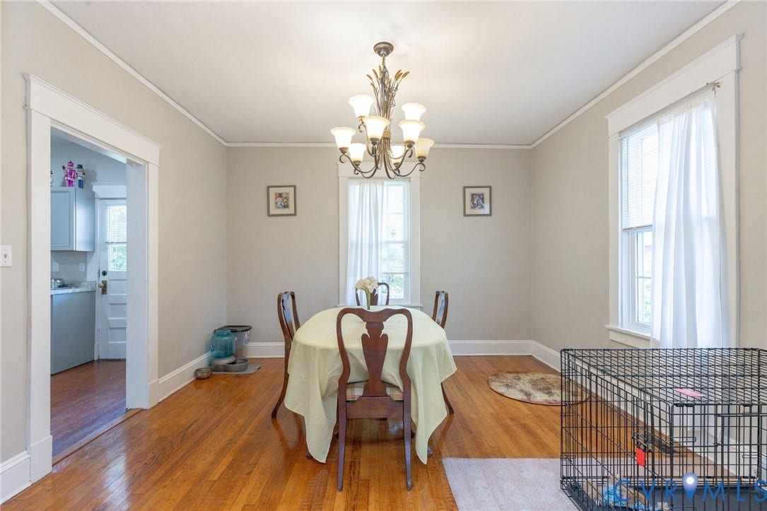 2726 Hanes Avenue, Brookland Park, Richmond, VA 23222 Hardwood flooring, crown molding, white trim, recessed windows, and a multi-arm chandelier