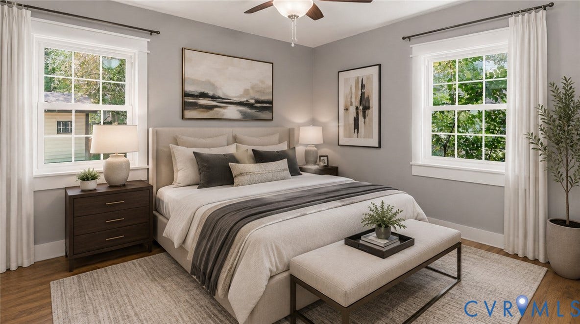 Wood-finish flooring, bright windows, and a ceiling fan with integrated lighting