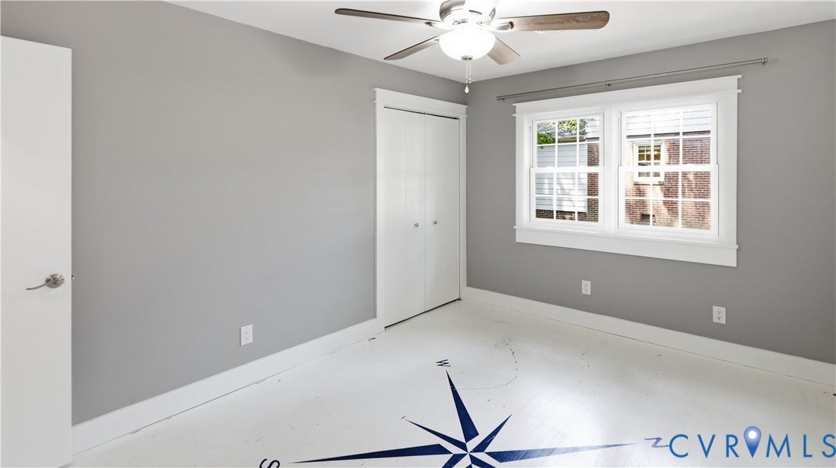 Light gray walls, white trim, and a ceiling fan with integrated lighting