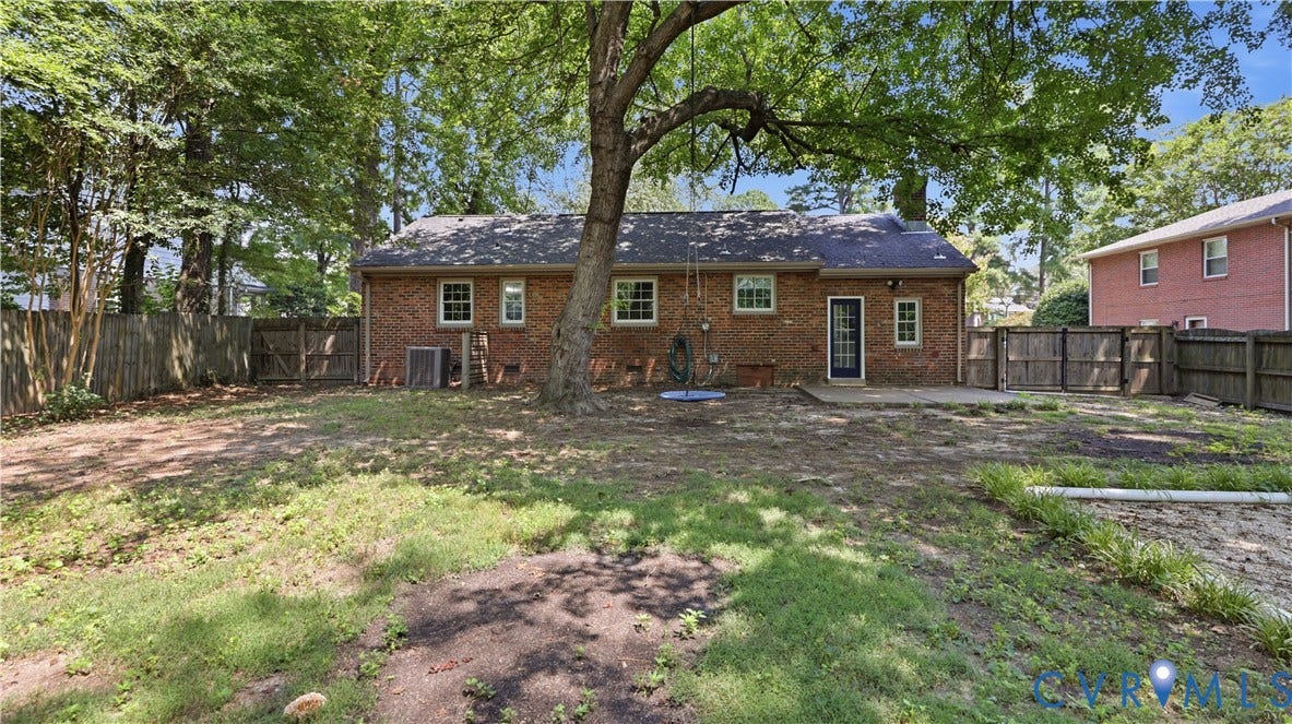 Brick exterior with multiple windows and a rear door