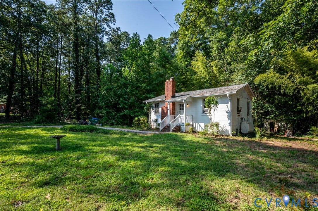 7107 Old Westham Road, Stratford Hills, Richmond, VA 23225 White exterior with a brick chimney, front porch, and white railings