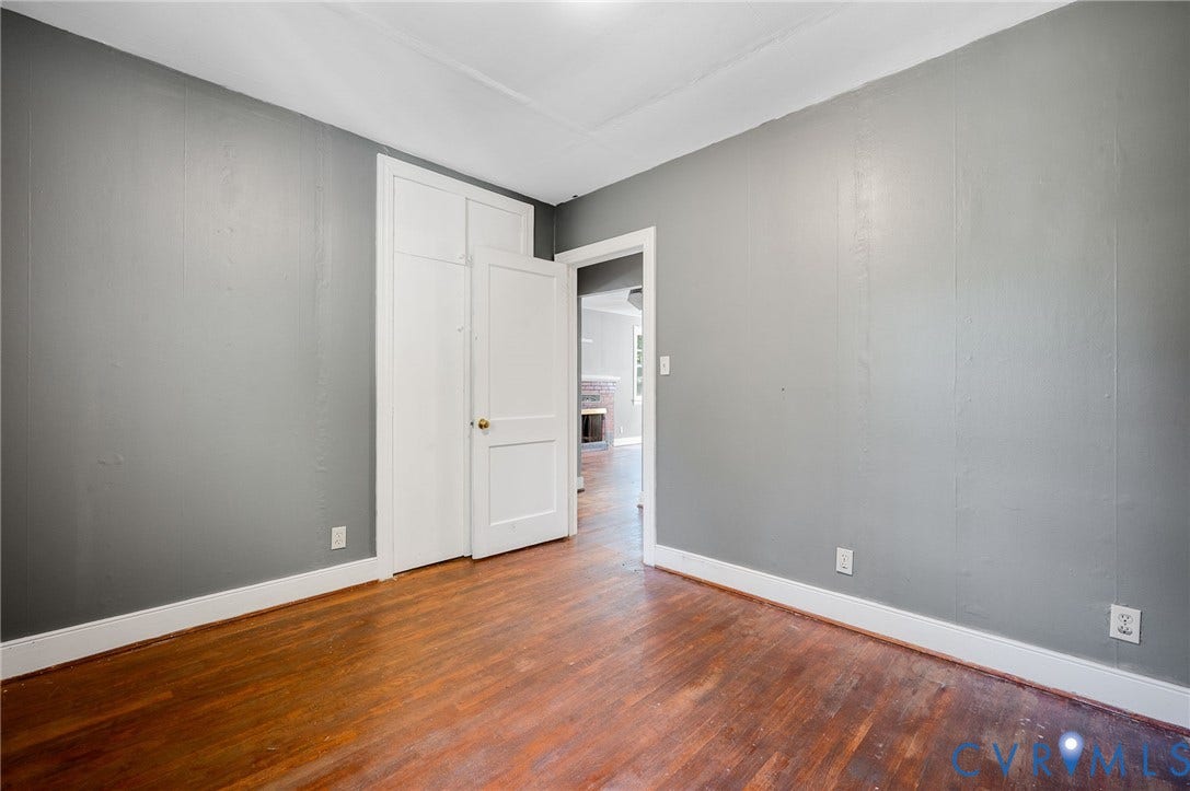 7107 Old Westham Road, Stratford Hills, Richmond, VA 23225 Hardwood flooring, painted walls, white trim, and a built-in closet
