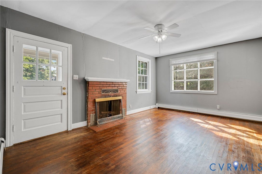 7107 Old Westham Road, Stratford Hills, Richmond, VA 23225 Hardwood flooring, brick fireplace with metal insert, multiple windows, ceiling fan with integrated lighting, and white trim