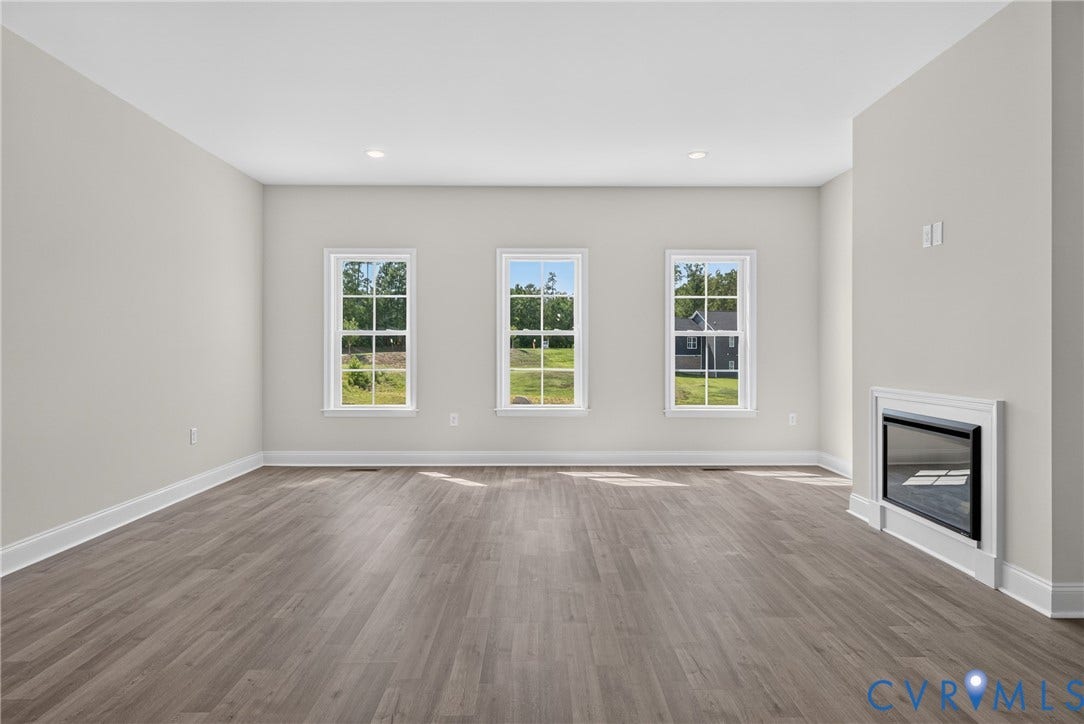 6541 Hardee Haven Place, Midlothian, VA 23112 Spacious room featuring wood-finish flooring, recessed lighting, and three bright windows
