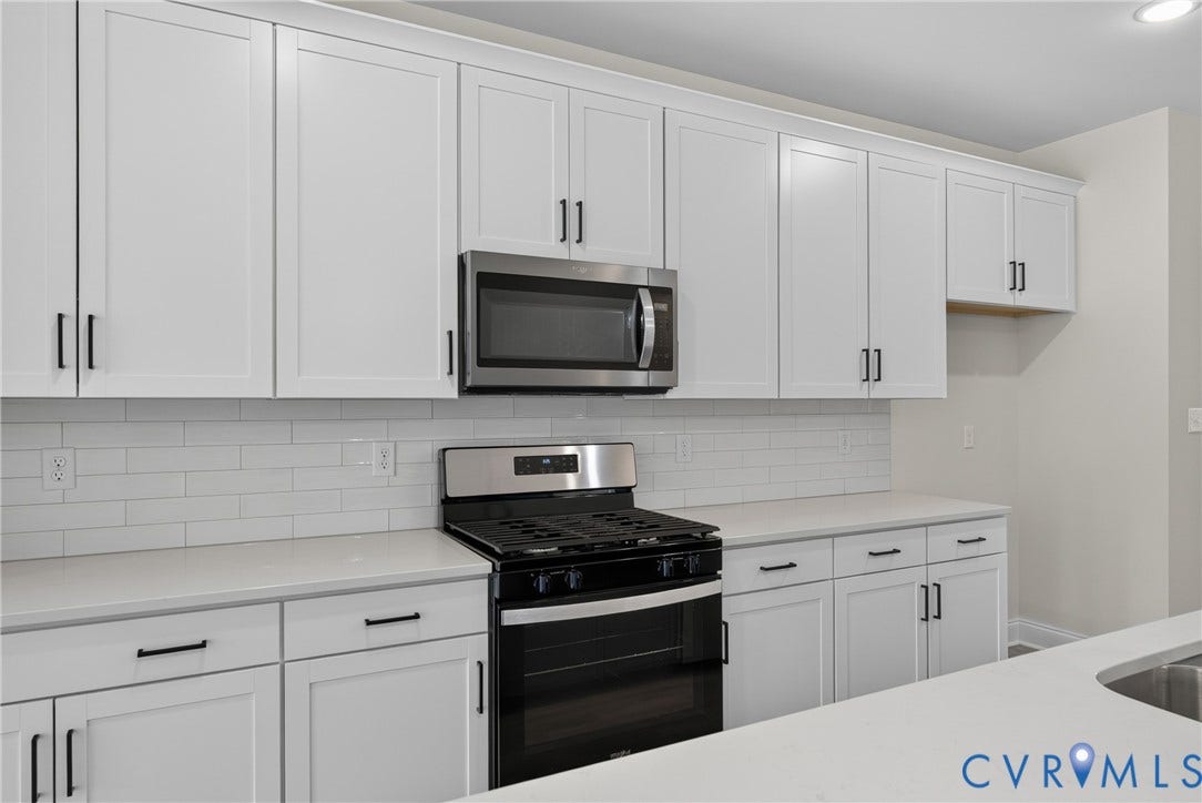 6541 Hardee Haven Place, Midlothian, VA 23112 White shaker cabinetry, stainless steel appliances, subway tile backsplash, light-toned countertops, and matte black hardware