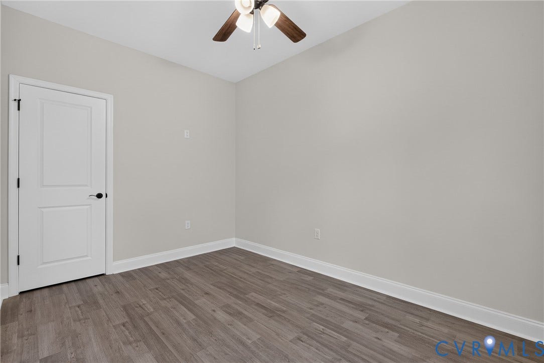 6541 Hardee Haven Place, Midlothian, VA 23112 Wood-finish flooring, white paneled door with matte black hardware, and a ceiling fan with light fixture