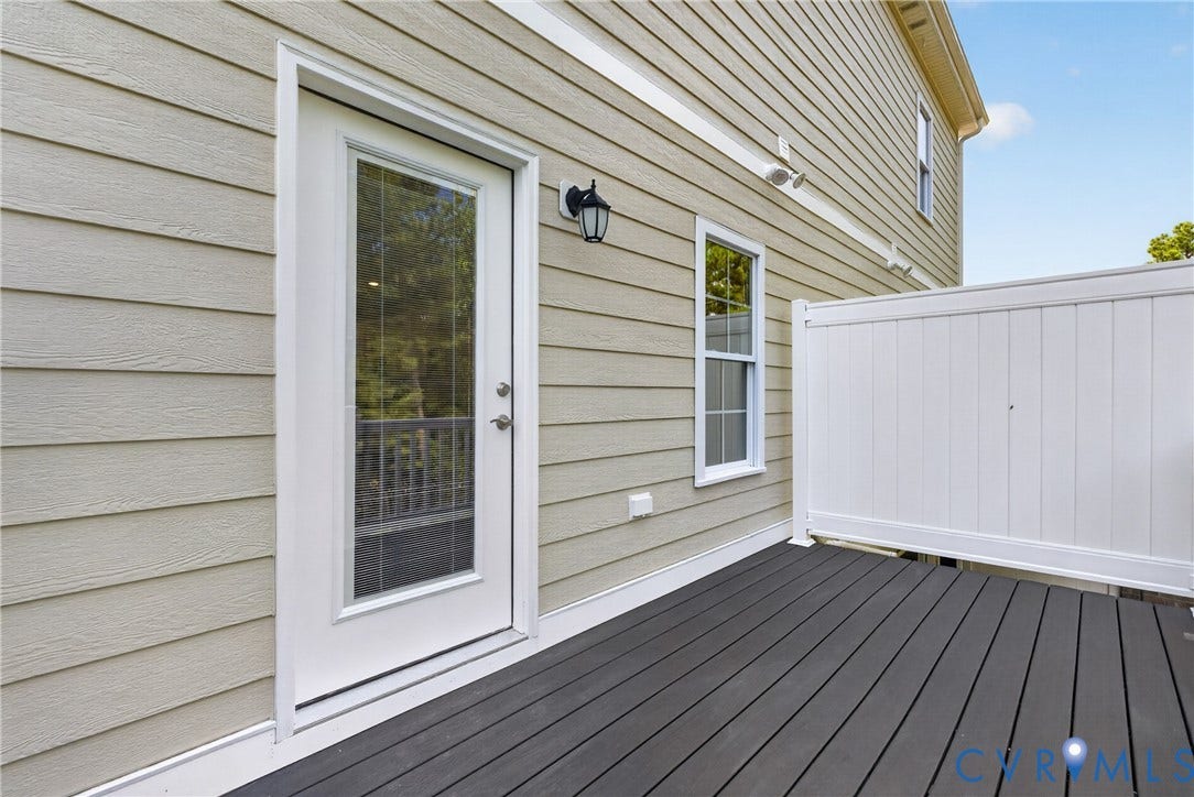 6541 Hardee Haven Place, Midlothian, VA 23112 Exterior deck featuring composite decking, white privacy fencing, and a full-light door