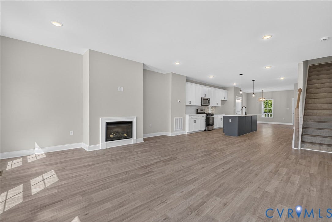 6541 Hardee Haven Place, Midlothian, VA 23112 Open-concept living area featuring wood-finish flooring and a contemporary fireplace